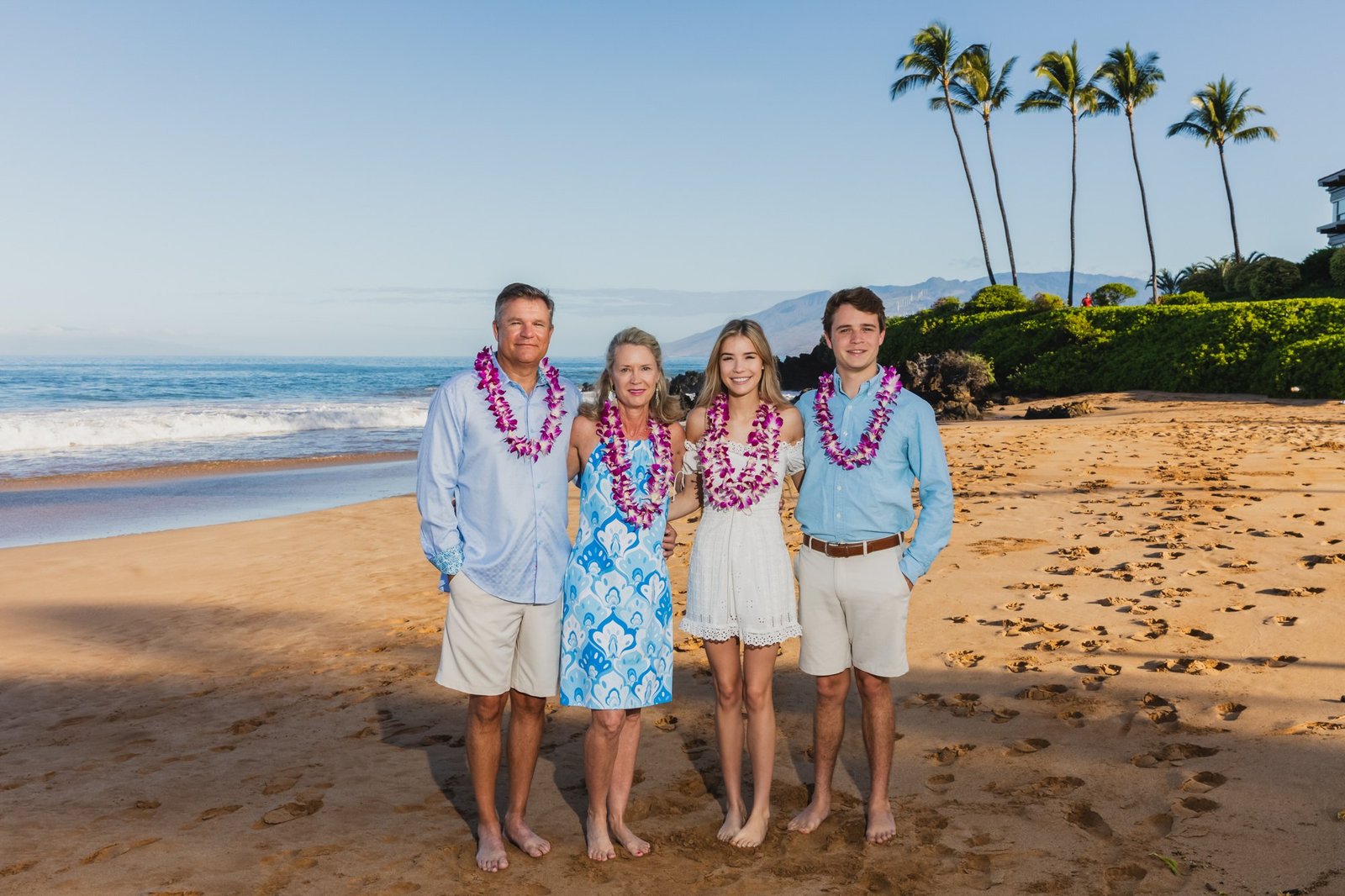 Family in leis on the sand at Wailea