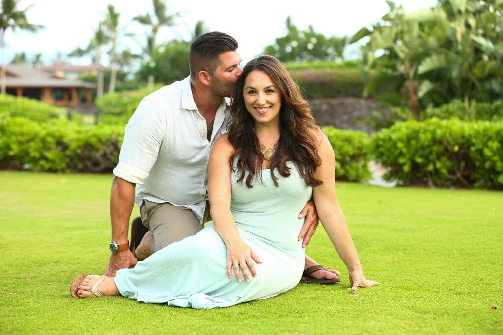Couple on the lawn by the lagoon at Fairmont Orchid